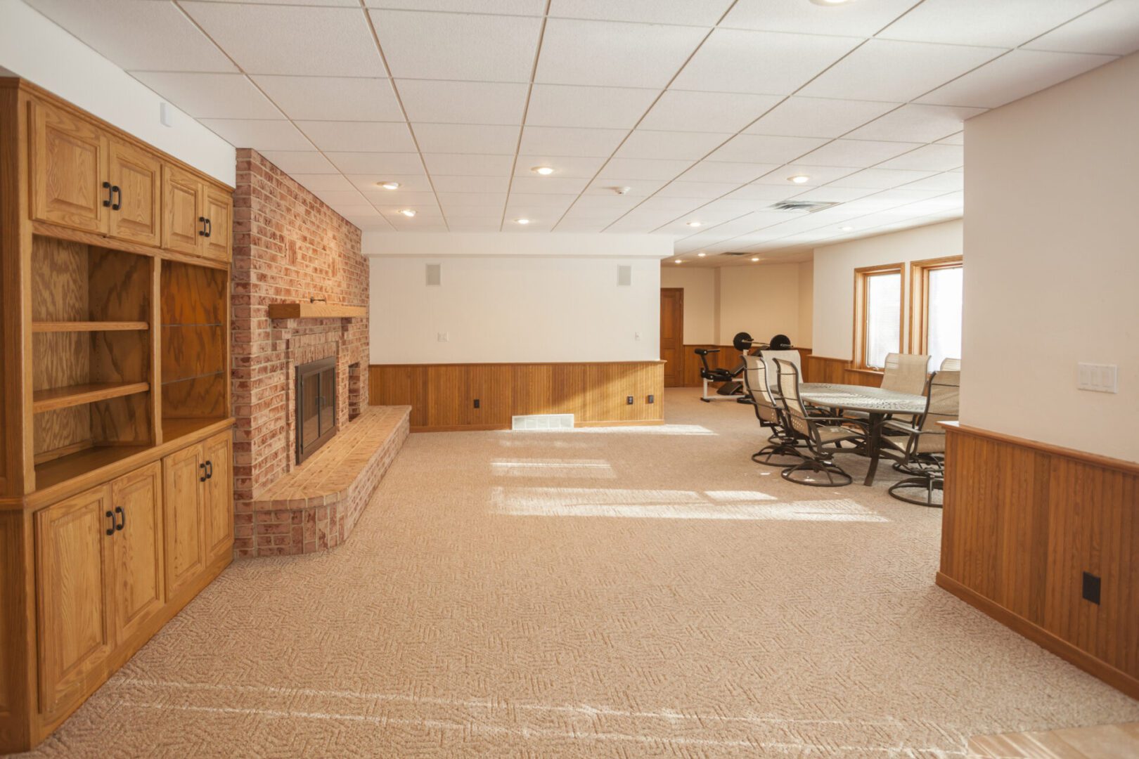 Spacious basement with fireplace and seating area.