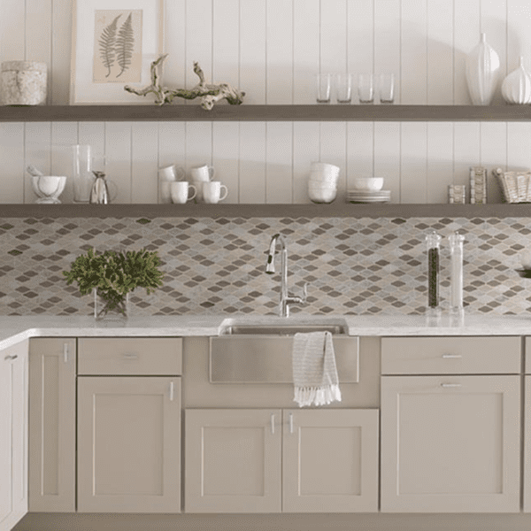 Modern kitchen with light cabinetry and patterned backsplash.